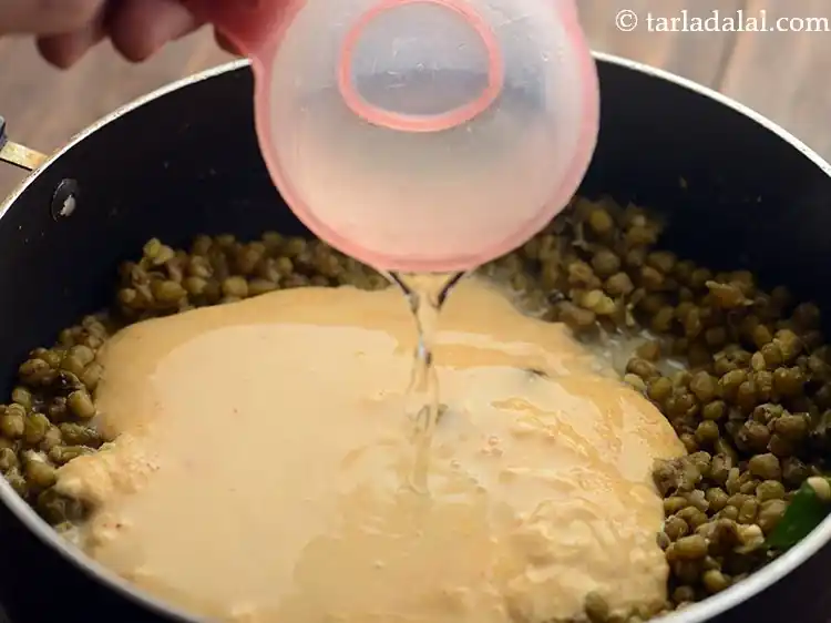 Step 24 – <p>Add salt and 1 cup of water to adjust the consistency of <strong>Gujarati Khatta Mag</strong>. …