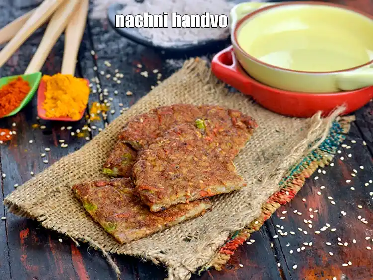 Step 51 – <p><span style="background-color:rgb(255,255,255);color:rgb(0,0,0);">Cut each <strong>Poha Nachni Handvo</strong> into 4 equal portions and serve immediately.</span></p>