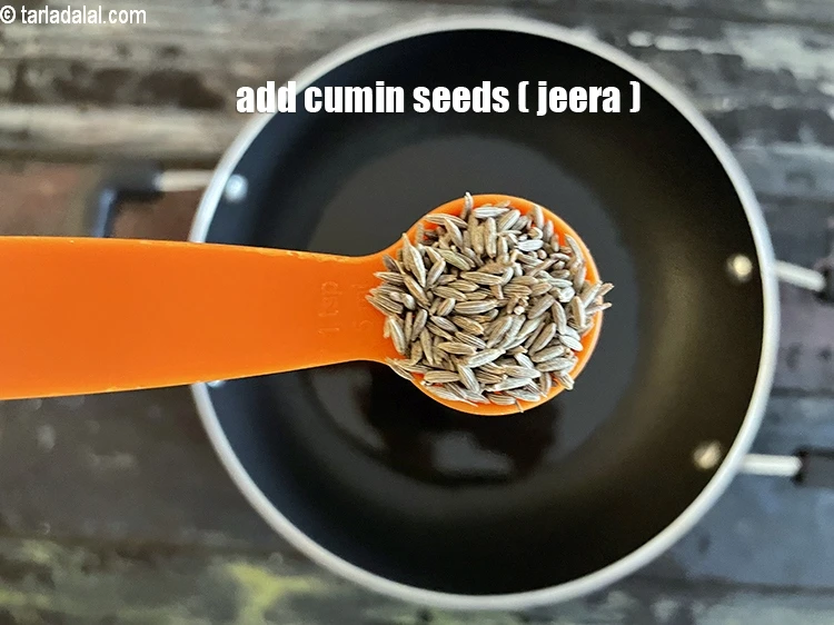 Step 13 – <html><head></head><body><p>Add&nbsp;1 tsp&nbsp;<a href="glossary-cumin-seeds-jeera-zeera-381i">cumin seeds (jeera)</a>.</p></body></html>