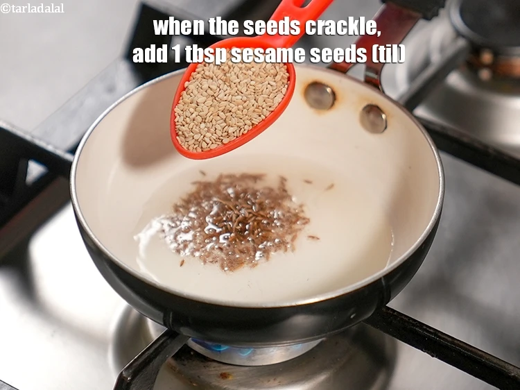Step 33 – <p>When the seeds crackle, add 1 tbsp&nbsp;<a href="https://www.tarladalal.com/glossary-sesame-seeds-til-gingelly-seeds-612i">sesame seeds (til)</a>.</p>