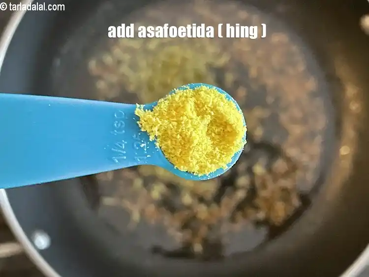 Step 25 – <html><head></head><body><p>Add&nbsp;1/4 tsp&nbsp;<a href="glossary-asafoetida-hing-113i">asafoetida (hing)</a>.</p></body></html>