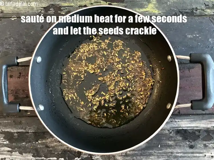 Step 26 – <p>Sauté on a medium flame for a few seconds and let the seeds crackle.&nbsp;</p>