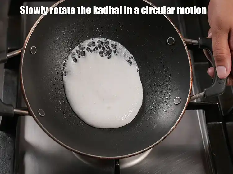Step 34 – <p>Slowly rotate the kadhai in a circular motion so that a thin layer forms on …