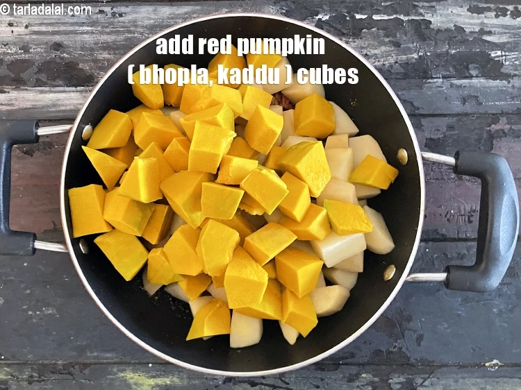 Step 21 – <html><head></head><body><p>Add&nbsp;2 1/4 cups&nbsp;<a href="glossary-red-pumpkin-cubes-1530i">peeled red pumpkin (bhopla / kaddu) cubes</a>.</p></body></html>