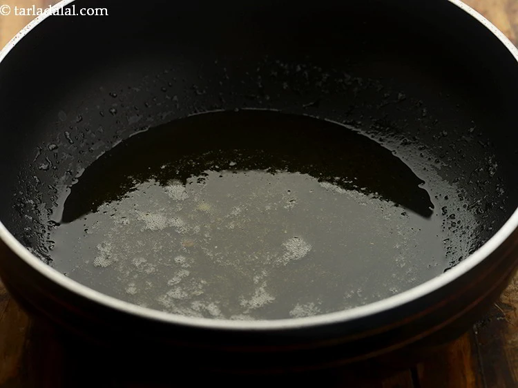 Step 33 – <p>To temper, the dal for <strong>dal bati churma</strong>,&nbsp; heat the ghee in a deep non-stick …