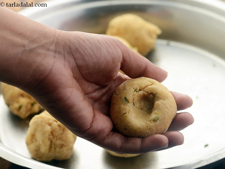 Step 61 – <p>Make a small indentation in the center of the baatis using your thumb. You can …