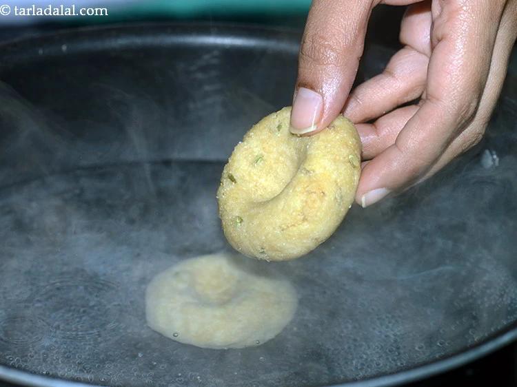 Step 62 – <p>Boil enough water in a deep non-stick kadhai and carefully add all the baatis into …