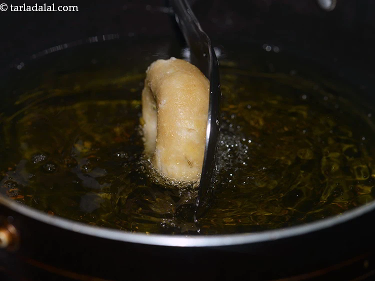 Step 64 – <p>Heat the ghee in a deep non-stick kadhai, add 4 baatis at a time.</p>