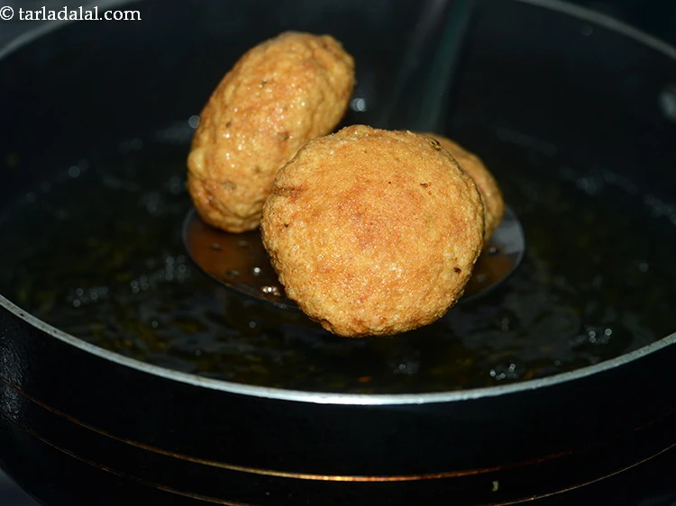 Step 65 – <p>Deep-fry till they turn golden brown in color from all the sides.</p>