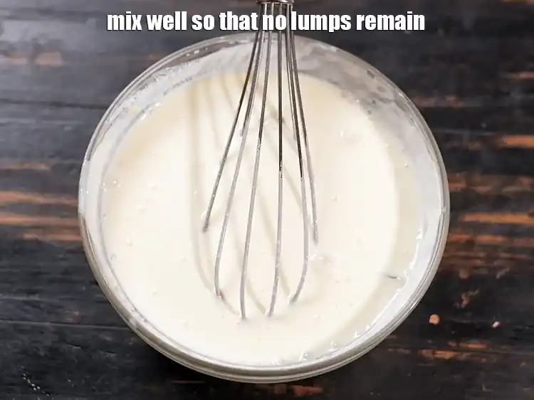 Step 25 – <p>Mix curd besan mixture&nbsp;well with a whisk so that no lumps remain. Ensure that no …