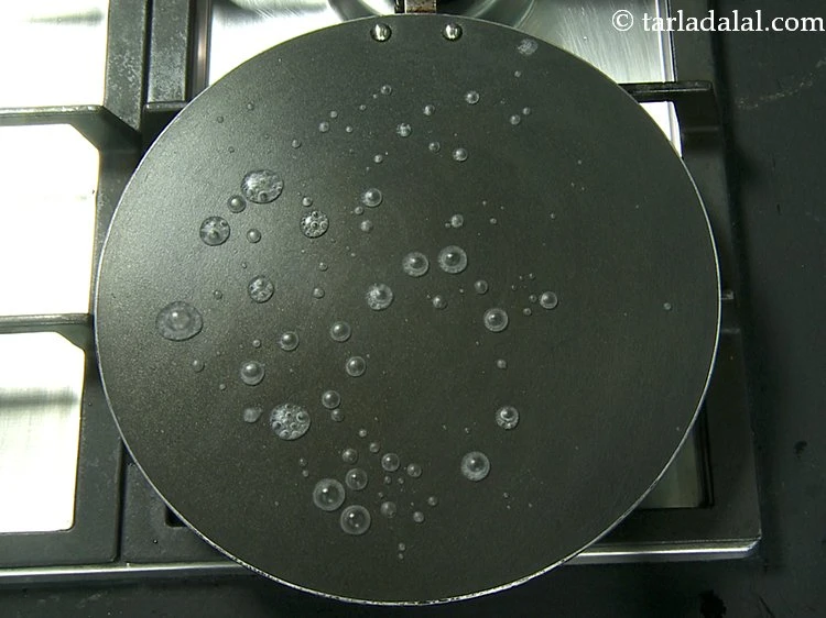 Step 16 – <p>Heat a non-stick tava (griddle), to check whether tawa is medium hot or not, sprinkle …