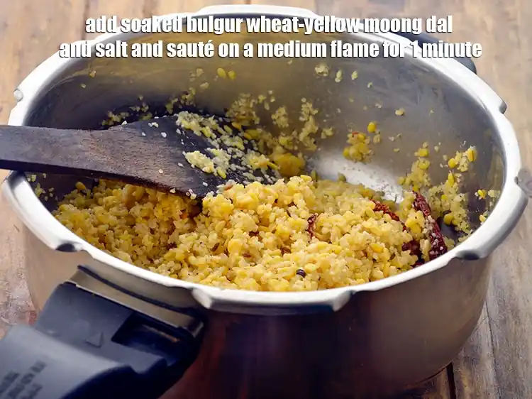 Step 10 – <p><span style="background-color:rgb(255,255,255);color:rgb(0,0,0);">Add the <strong>soaked bulgur wheat-yellow moong dal </strong>and </span>1/4 tsp <a href="https://www.tarladalal.com/glossary-salt-namak-table-salt-418i"><u>salt</u></a><span style="background-color:rgb(255,255,255);color:rgb(0,0,0);"> and …