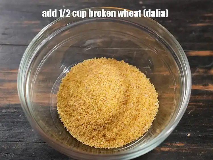 Step 2 – <p>Add 1/2 cup <a href="https://www.tarladalal.com/glossary-broken-wheat-dalia-bulgur-wheat-lapsi-fada-426i"><u>broken wheat (dalia)</u></a><u>.</u></p>