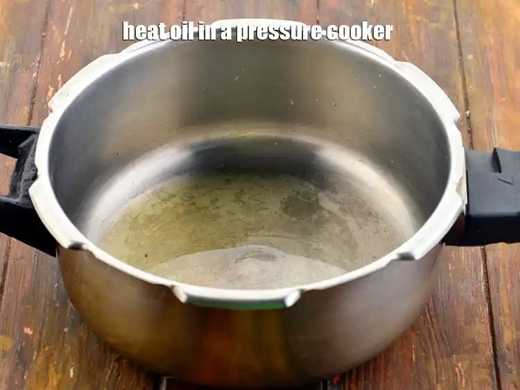 Step 7 – <p><span style="background-color:rgb(255,255,255);color:rgb(0,0,0);">Heat the </span>2 tsp <a href="https://www.tarladalal.com/glossary-oil-671i"><u>oil</u></a><span style="background-color:rgb(255,255,255);color:rgb(0,0,0);"> in a pressure cooker.</span></p>