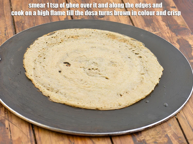 Step 25 – <p>Smear 1 tsp of ghee over it and along the edges and cook on a …