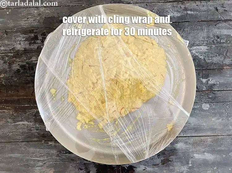 Step 15 – <p>Cover with a cling wrap.&nbsp;Refrigerate the&nbsp;<strong>Kesar Peda</strong>&nbsp;mixture for 30 minutes. This makes the process of …