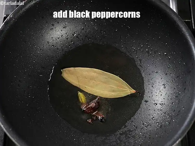 Step 24 – <p>Add 3 <a href="https://www.tarladalal.com/glossary-black-peppercorns-kali-mirch-kalimirch-566i">black peppercorns (kalimirch)</a>.</p>