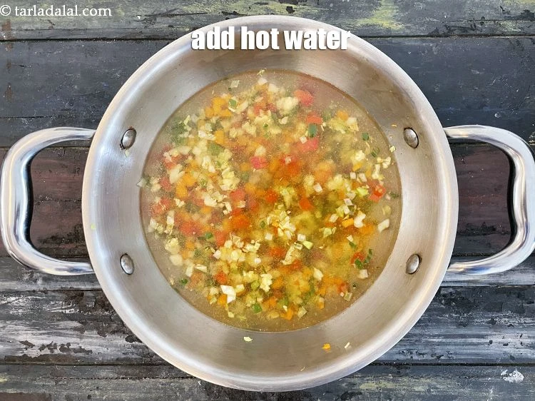 Step 13 – <p>Add 3 cups of hot water to the wok of sauted vegetables.</p>