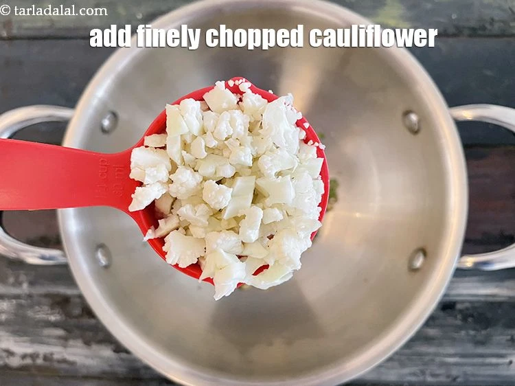 Step 7 – <p>Add 1/4 cup&nbsp;finely&nbsp;<a href="glossary-chopped-cauliflower-796i">chopped cauliflower</a>. Instead of chopping you can also use grated cauliflower.</p>