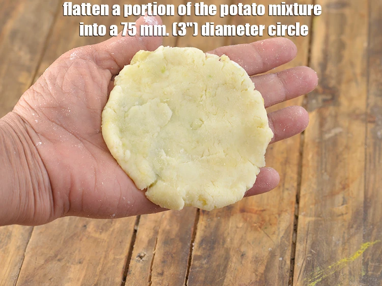 Step 11 – <p><span style="background-color:rgb(255,255,255);color:rgb(0,0,0);">Flatten a portion of the potato mixture into a 75 mm. (3") diameter circle.</span></p>