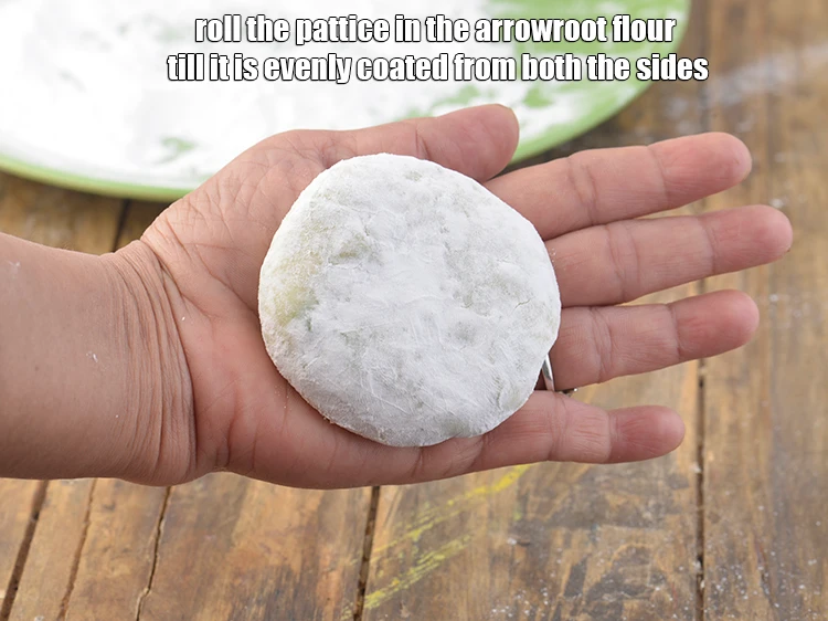 Step 15 – <p>Roll the pattice in the <a href="https://www.tarladalal.com/glossary-arrowroot-flour-arrowroot-ka-atta-paniphal-flour-111i"><u>arrowroot (paniphal) flour</u></a> till it is evenly coated from …