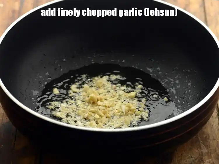 Step 17 – <p>Once the oil is hot, add the 1 tbsp finely <a href="https://www.tarladalal.com/glossary-garlic-lehsun-lahsun-348i#ing_2370"><u>chopped garlic (lehsun)</u></a><u>.</u></p>