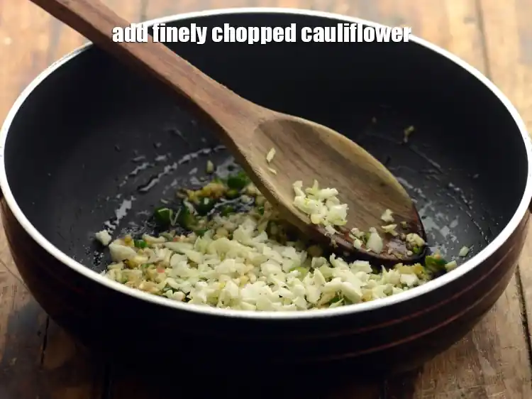 Step 21 – <p>Add 2 tbsp finely <a href="https://www.tarladalal.com/glossary-cauliflower-phool-gobi-phool-gobhi-174i#ing_2374"><u>chopped cauliflower</u></a>. Clean and chop the cauliflower well to get …