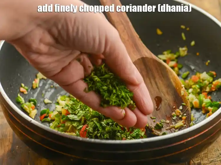 Step 26 – <p>Add 1/2 tbsp finely <a href="https://www.tarladalal.com/glossary-coriander-dhania-kothmir-369i#ing_2365"><u>chopped coriander (dhania)</u></a><u>.</u></p>