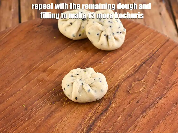 Step 10 – <p>Repeat with the remaining dough and filling to make 13 more <strong>kochuris</strong>.</p>