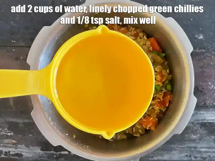 Step 8 – <p><span style="background-color:rgb(255,255,255);color:rgb(0,0,0);">Add 2 cups of water, </span>2 tsp finely <a href="https://www.tarladalal.com/glossary-green-chillies-hari-mirch-331i#ing_2388"><u>chopped green chillies</u></a><span style="background-color:rgb(255,255,255);color:rgb(0,0,0);"> and …