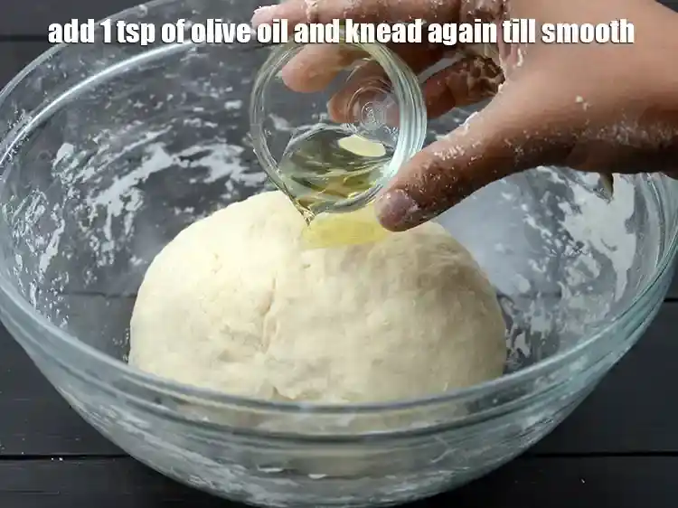 Step 12 – <p>Add 1 tsp of <a href="https://www.tarladalal.com/glossary-olive-oil-451i">olive oil</a> and knead again till smooth.&nbsp;</p>