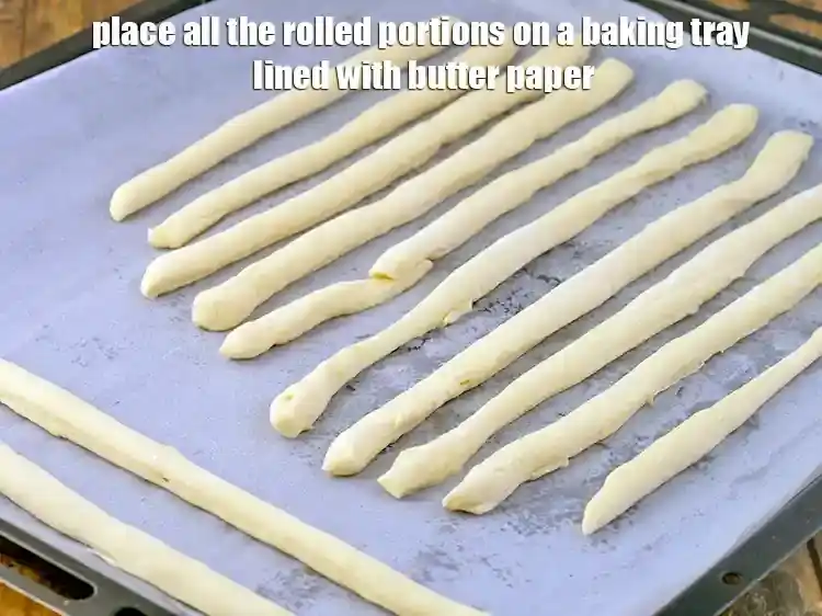 Step 19 – <p>Place all the rolled portions on a baking tray lined with butter paper.</p>