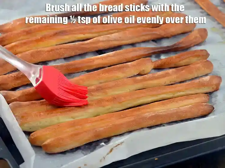 Step 21 – <p>Brush all the bread sticks with the remaining ½ tsp of <a href="https://www.tarladalal.com/glossary-olive-oil-451i">olive oil</a> evenly …