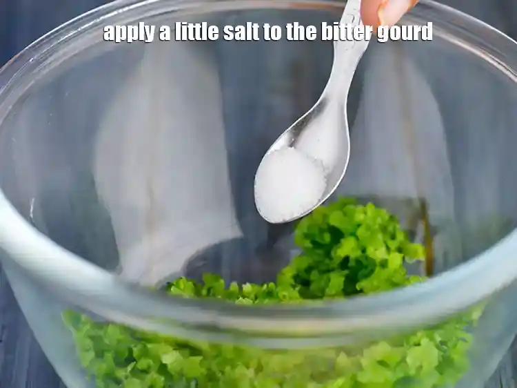 Step 4 – <p><span style="background-color:rgb(255,255,255);color:rgb(0,0,0);">Apply a little </span><a href="https://www.tarladalal.com/glossary-salt-namak-table-salt-418i"><u>salt</u></a><span style="background-color:rgb(255,255,255);color:rgb(0,0,0);"> to the bitter gourd.</span></p>