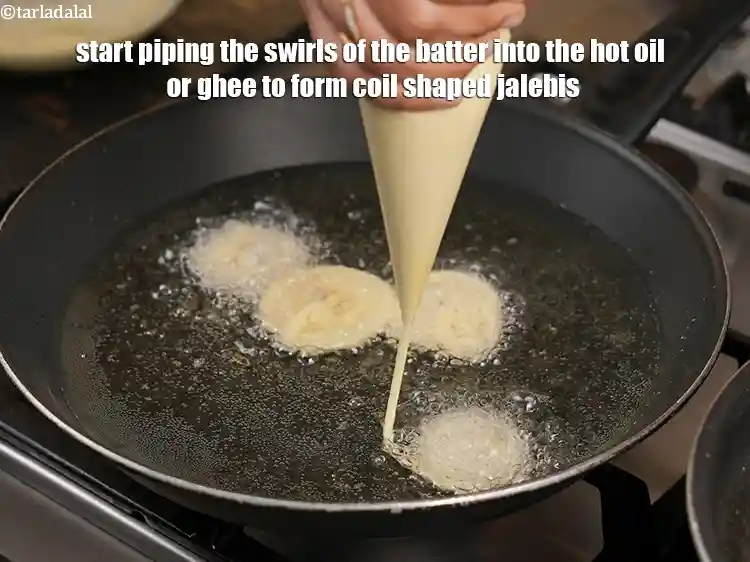 Step 24 – <p>Start piping the swirls of the batter into the hot oil or ghee to form …