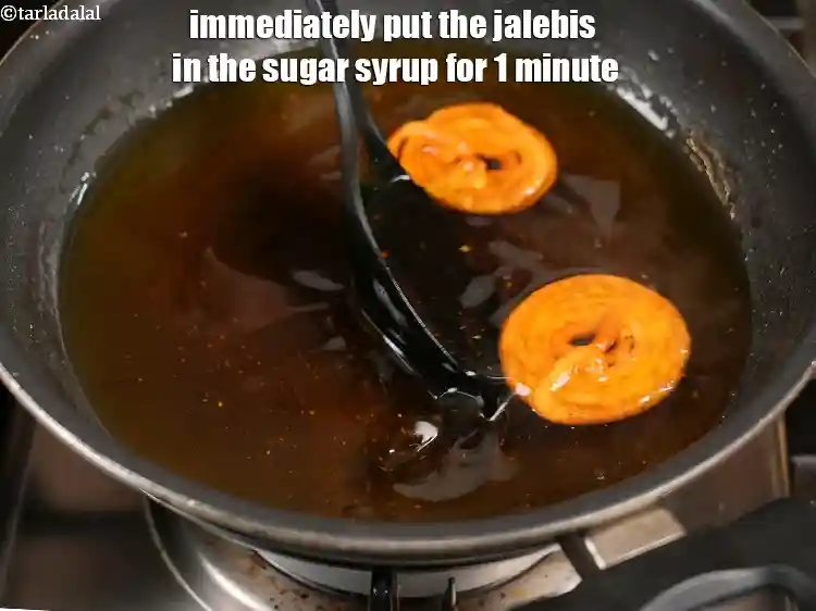 Step 27 – <p>Immediately put the jalebis in the sugar syrup for 1 minute.</p>