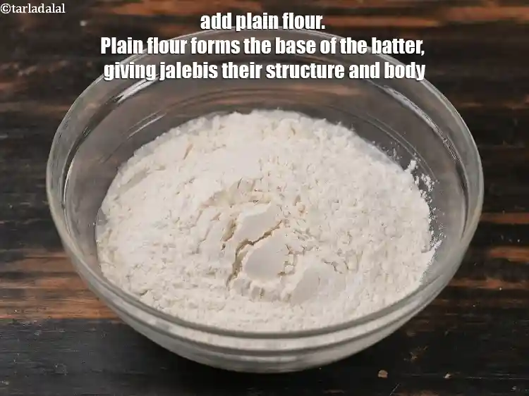 Step 6 – <p>Add 1½ cups of <a href="https://tarladalal.com/glossary-plain-flour-maida-188i">plain flour (maida)</a>.&nbsp;Plain flour forms the base of the batter, …