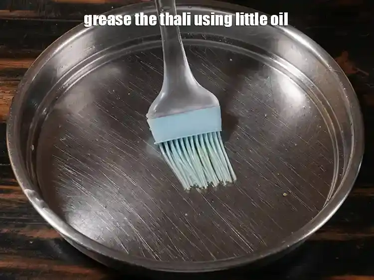 Step 6 – <p><span style="background-color:rgb(255,255,255);color:rgb(0,0,0);">Grease the thali using little </span><a href="https://www.tarladalal.com/glossary-oil-671i"><u>oil</u></a><span style="background-color:rgb(255,255,255);color:rgb(0,0,0);">. </span>Pour half the batter into a …