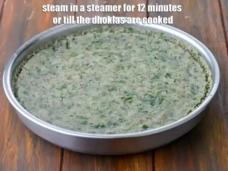 Step 7 – <p>Steam in a steamer for 12 minutes or till the <strong>dhoklas</strong> are cooked.</p>