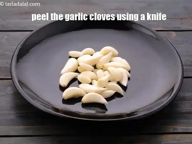 Step 3 – <p>Peel the garlic cloves using a knife and discard the peel.</p>