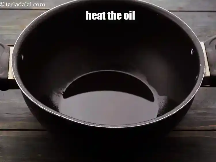 Step 5 – <p>To make <strong>bhadang, </strong>heat the <a href="https://www.tarladalal.com/glossary-oil-671i">oil</a> in a deep non-stick pan.</p>