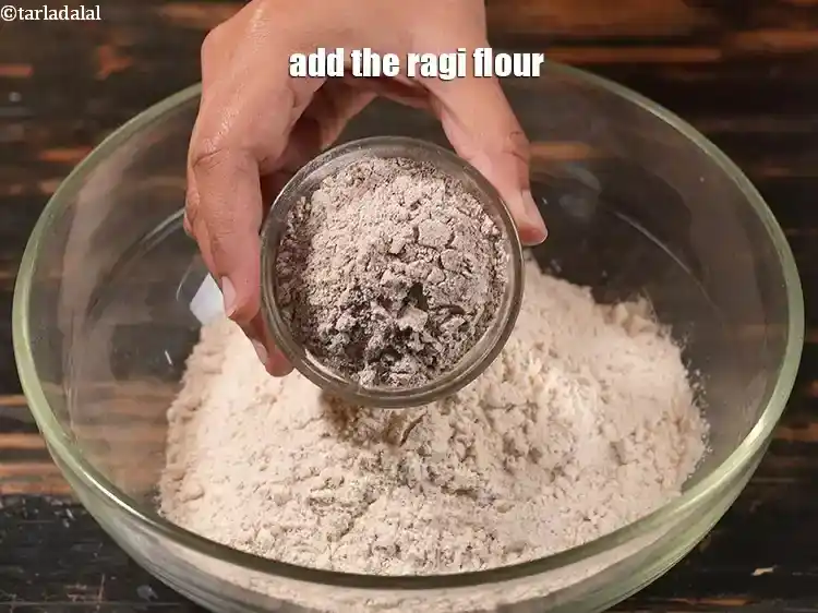 Step 14 – <p>Add 1/4 cup <a href="https://www.tarladalal.com/glossary-ragi-flour-nachni-flour-nachni-ka-atta-red-millet-flour-1115i"><u>ragi (nachni , red millet) flour</u></a><u>.</u></p>