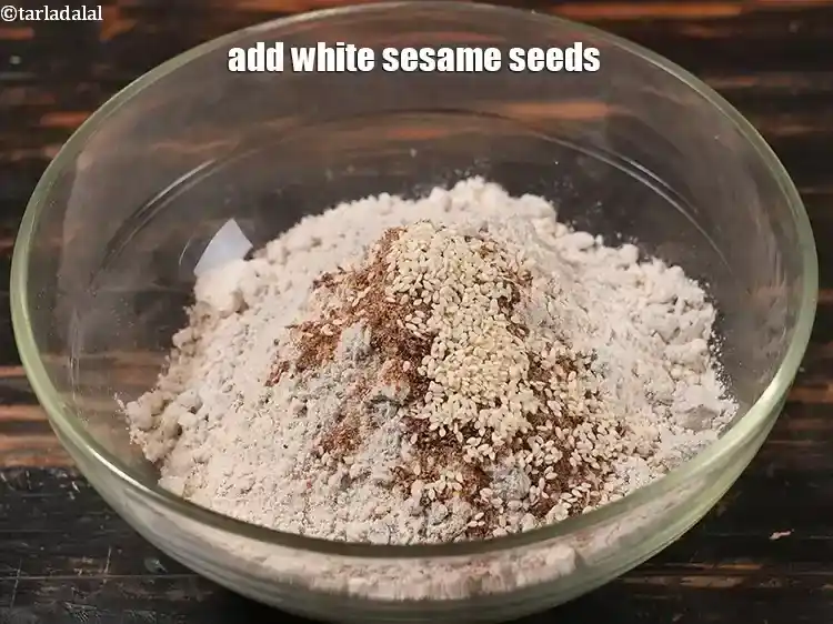 Step 18 – <p>Add 1 tsp white <a href="https://www.tarladalal.com/glossary-sesame-seeds-til-gingelly-seeds-612i"><u>sesame seeds (til)</u></a><u>.</u></p>