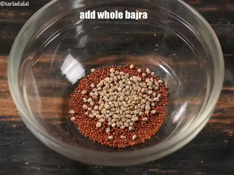Step 3 – <p>Add 1/2 tsp whole <a href="https://www.tarladalal.com/glossary-whole-bajra-black-millet-pearl-millet-175i"><u>whole bajra (black millet)</u></a><u>.</u></p>