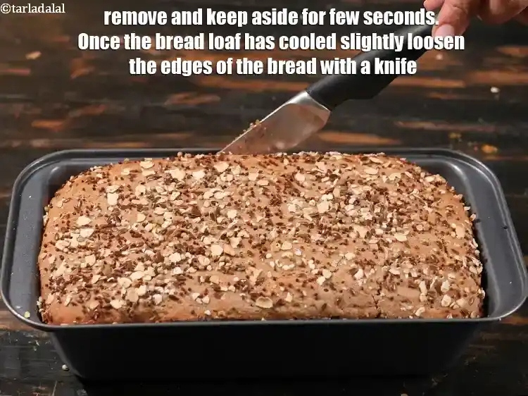 Step 35 – <p>Remove and keep aside for few seconds. Once the bread loaf has cooled slightly loosen …