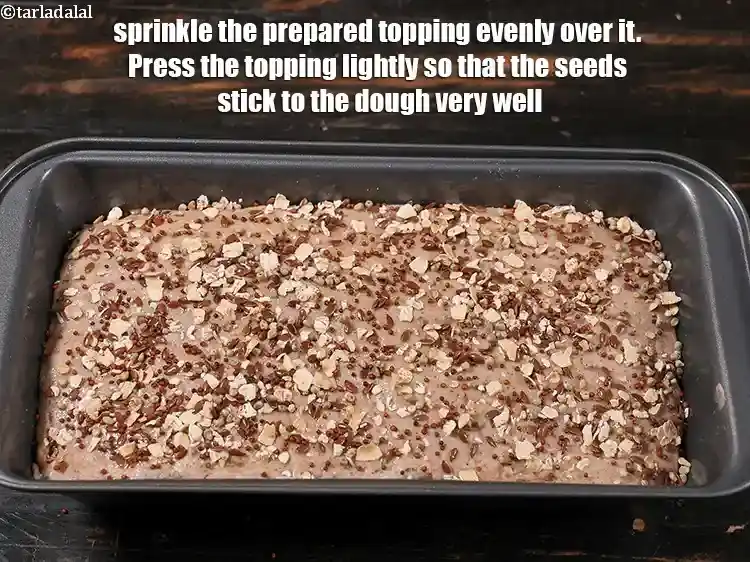 Step 32 – <p>Sprinkle the prepared topping evenly over it.&nbsp;Press the topping lightly so that the seeds stick …