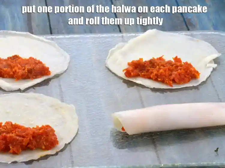 Step 25 – <p>Put one portion of the halwa on each pancake and roll them up tightly.</p>