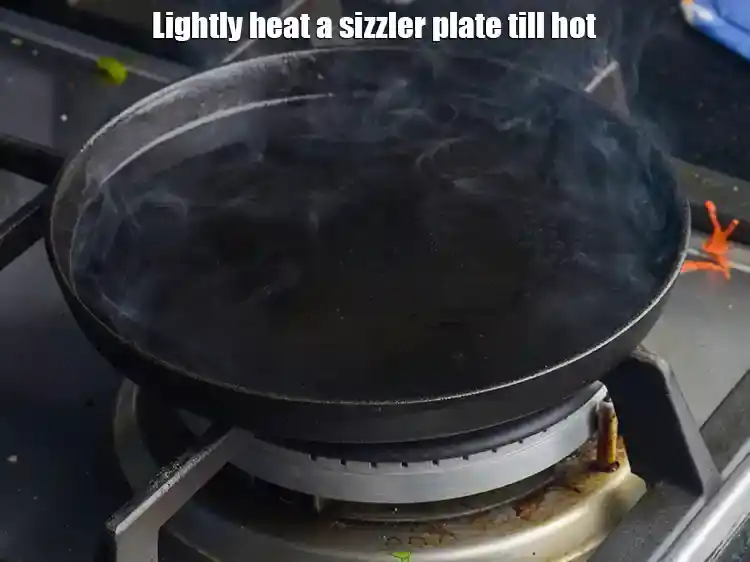 Step 26 – <p>Lightly heat a sizzler plate till hot (but not red hot as for the other …