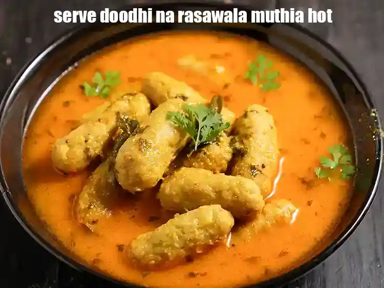 Step 29 – <p>Serve <strong>doodhi na rasawala muthia </strong>hot garnished with coriander.</p>