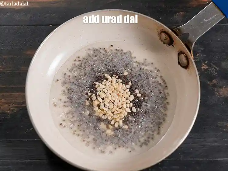 Step 11 – <p><span style="background-color:rgb(255,255,255);color:rgb(0,0,0);">Add ½ tsp </span><a href="https://www.tarladalal.com/glossary-urad-dal-split-black-lentil-941i"><u>urad dal (split black lentils)</u></a><span style="background-color:rgb(255,255,255);color:rgb(0,0,0);">.</span></p>
